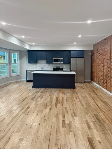 a large room with a bed and a large window