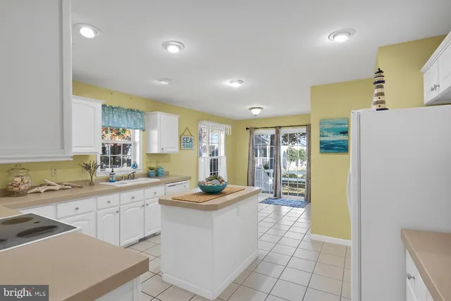 a kitchen with a sink a stove a refrigerator and cabinets