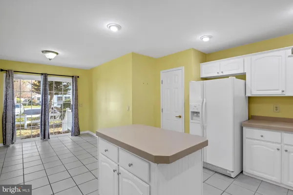 a kitchen with a cabinets and refrigerator