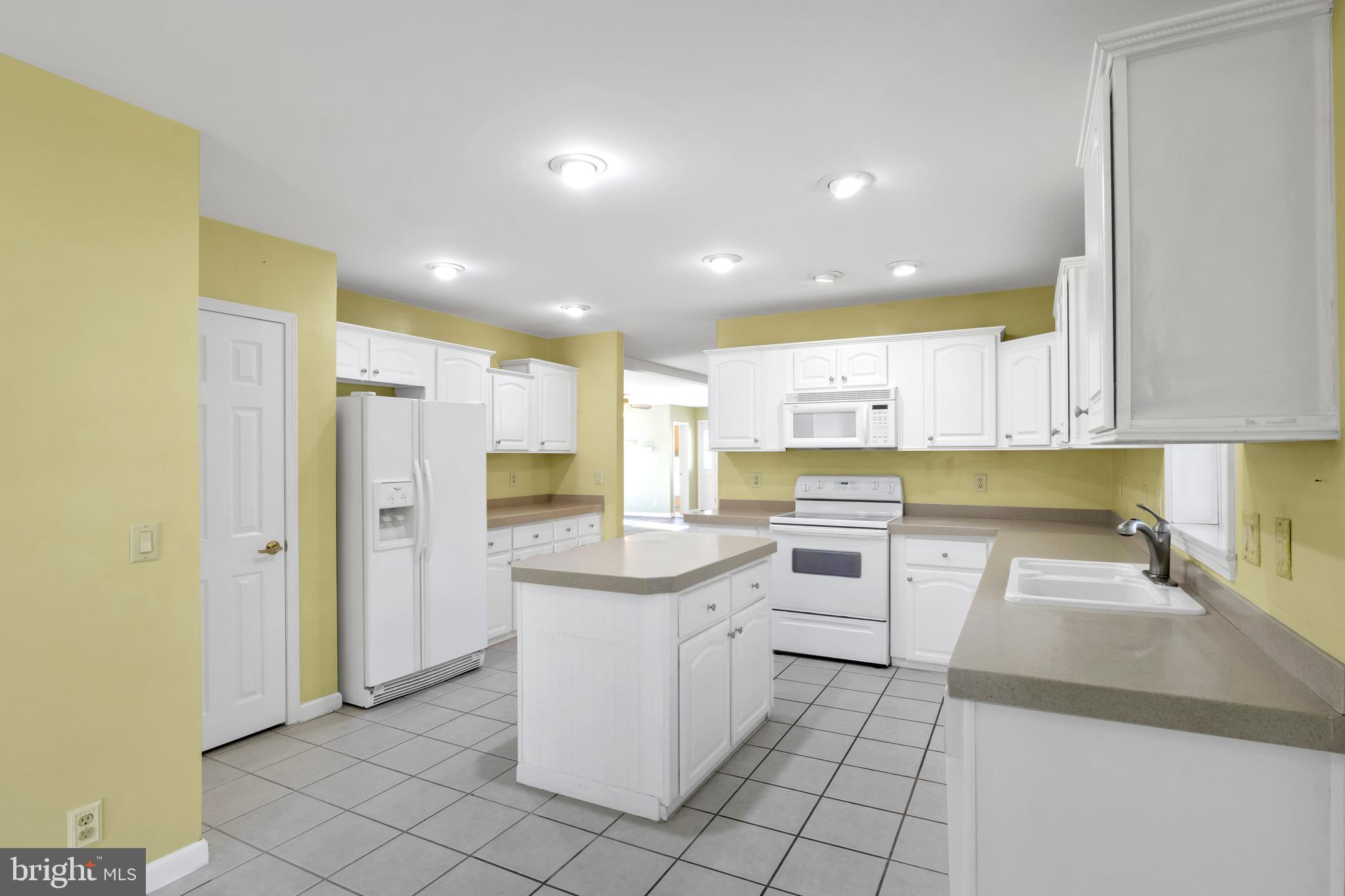 32530 Approach Way, Unit 3252 Millsboro, DE 19966 - Photo 16 of 54 a kitchen that has a lot of white cabinets and stainless steel appliances