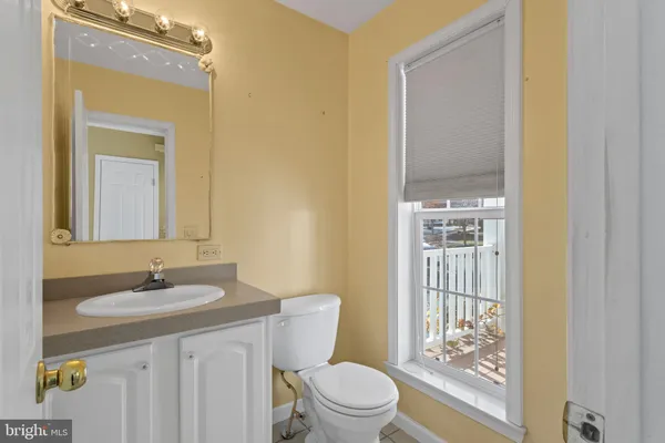 a bathroom with a toilet a sink and a mirror