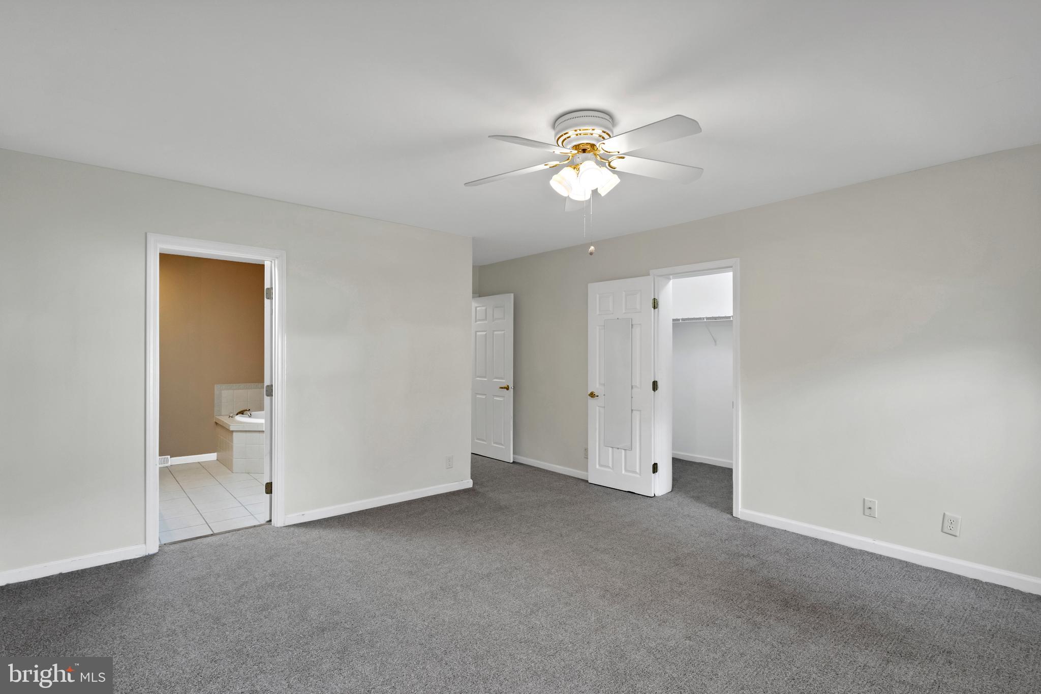 32530 Approach Way, Unit 3252 Millsboro, DE 19966 - Photo 22 of 54 a view of an empty room with a chandelier fan