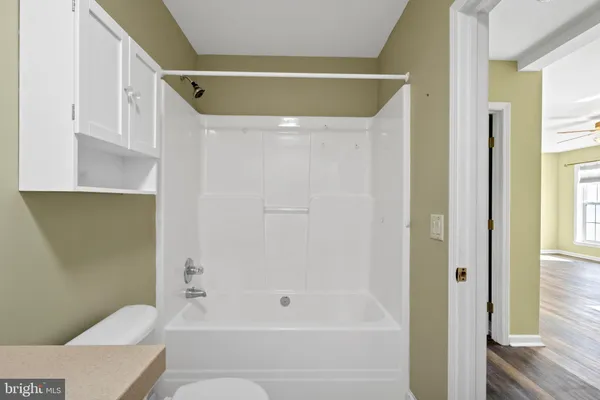 a bathroom with a sink toilet and mirror