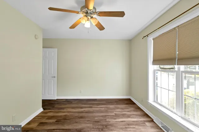 a spacious bathroom with a granite countertop sink and a mirror