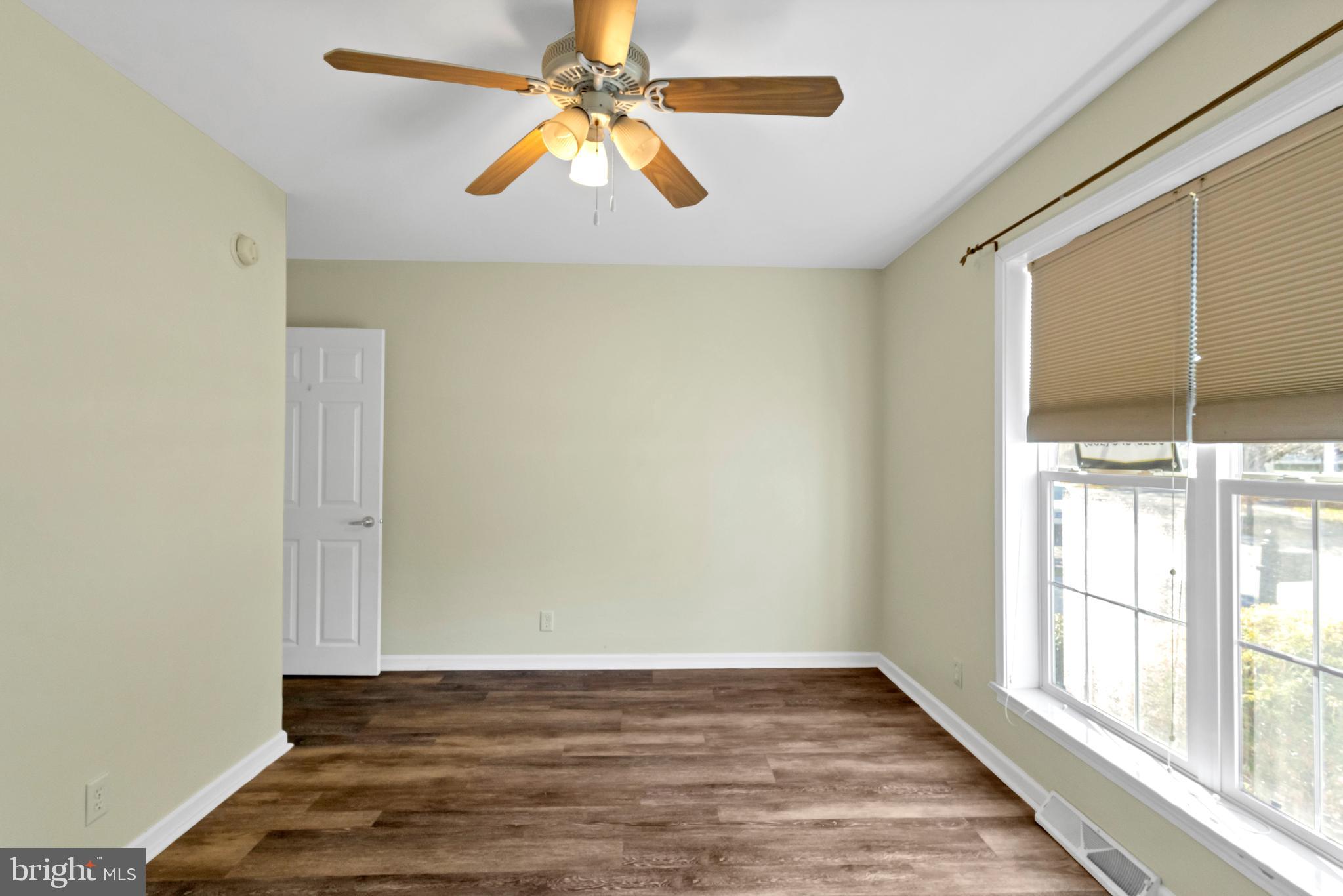 32530 Approach Way, Unit 3252 Millsboro, DE 19966 - Photo 32 of 54 a view of an empty room with window and wooden floor