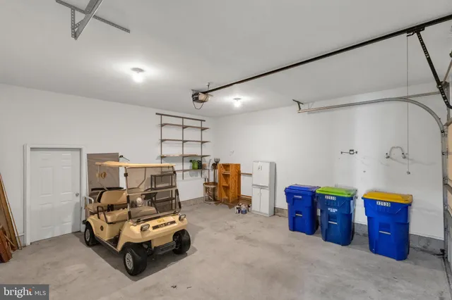 a view of a house with a small yard and a large tree