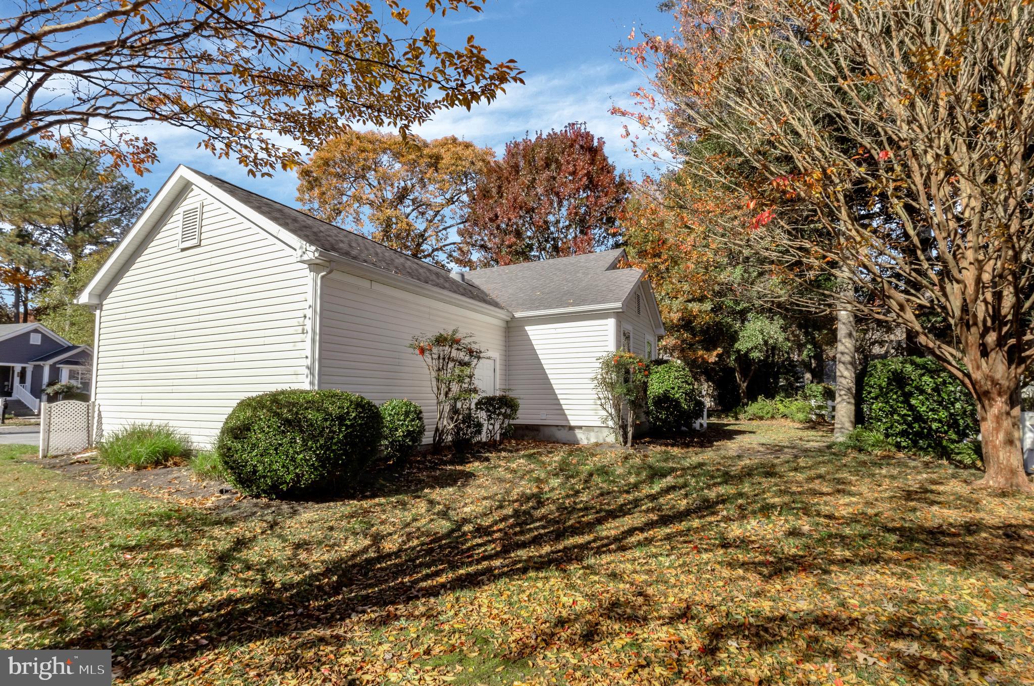 32530 Approach Way, Unit 3252 Millsboro, DE 19966 - Photo 38 of 54 a view of a house with a small yard and a large tree