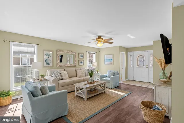 a living room with furniture wooden floor and a flat screen tv