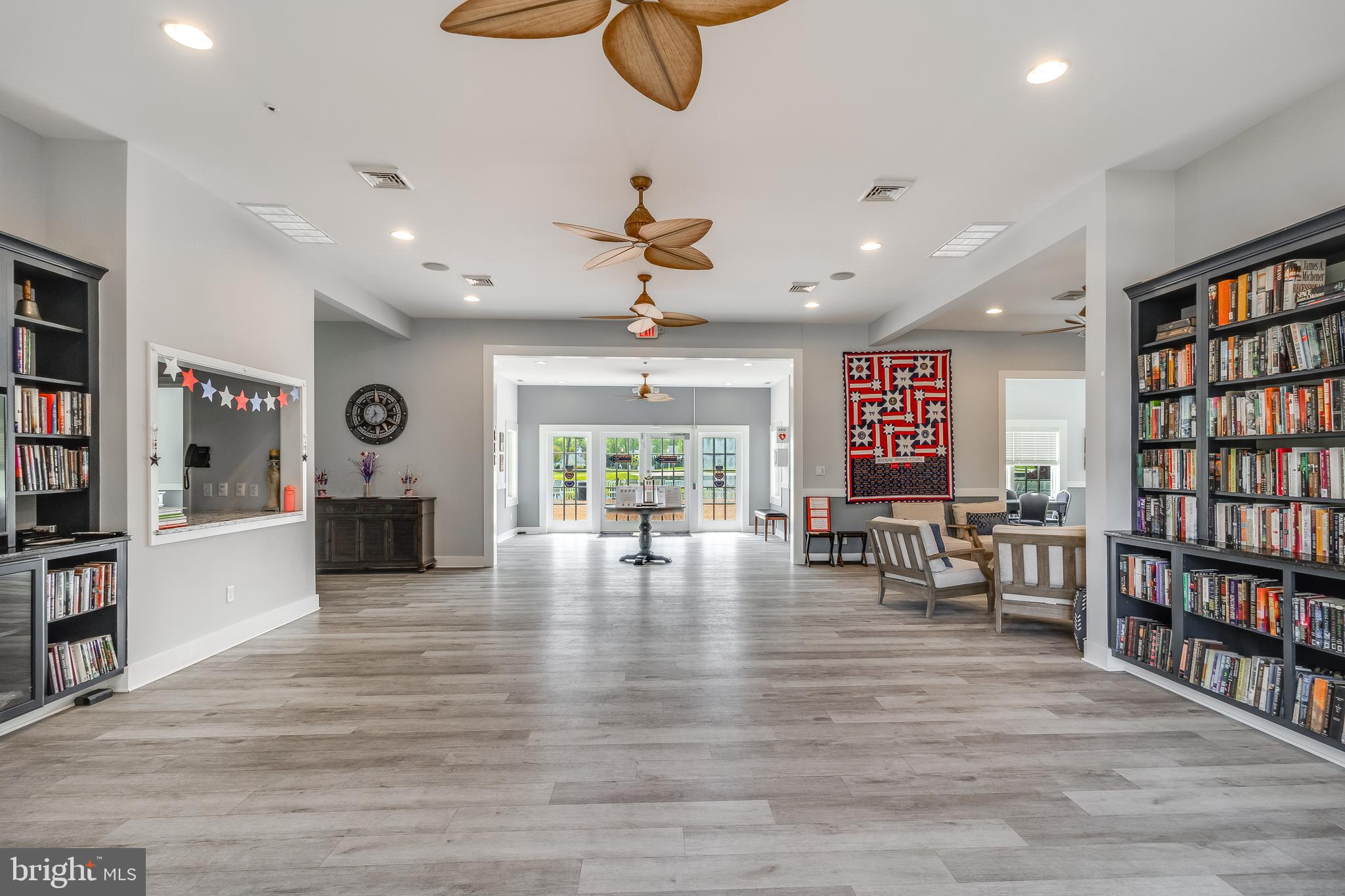 32530 Approach Way, Unit 3252 Millsboro, DE 19966 - Photo 41 of 54 a living room with furniture and a book shelf
