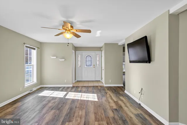 wooden floor in an empty room with a window