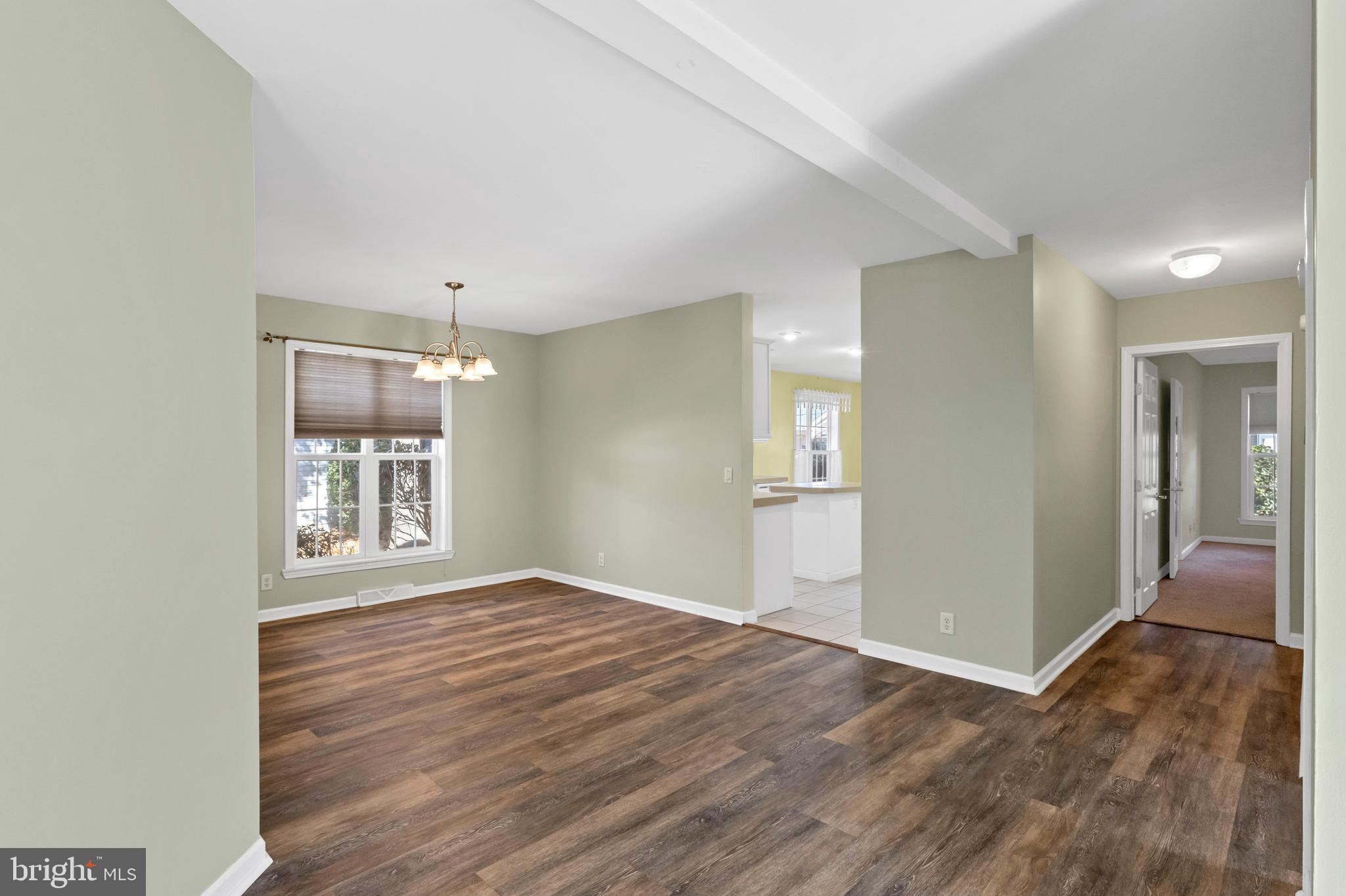 32530 Approach Way, Unit 3252 Millsboro, DE 19966 - Photo 10 of 54 a view of an empty room with wooden floor and a window