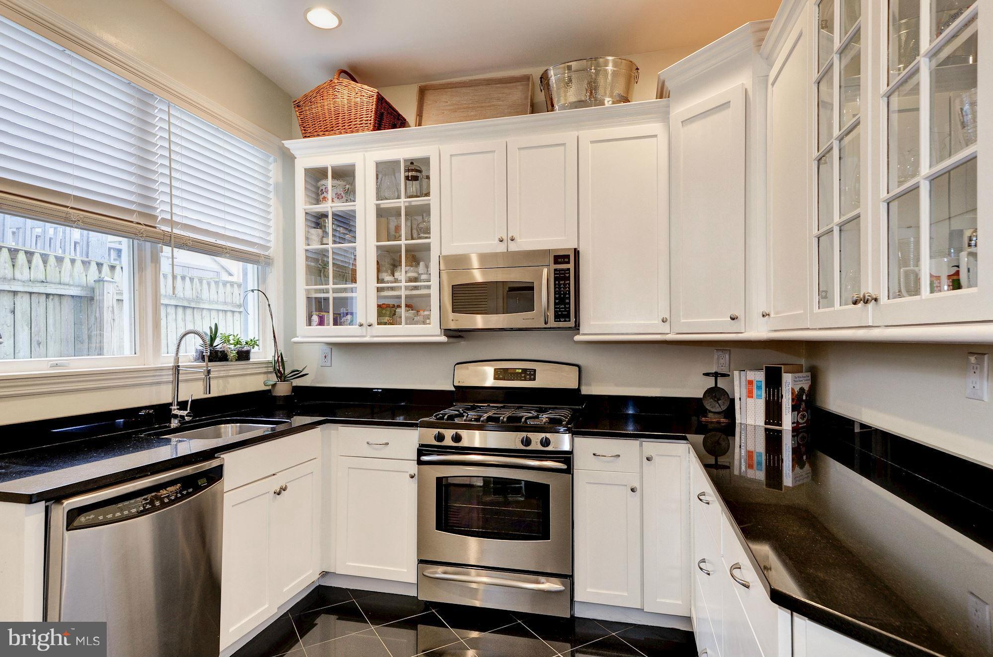 17 15th Street Southeast Washington, DC 20003 - Photo 12 of 28 a kitchen with granite countertop a stove sink and cabinets