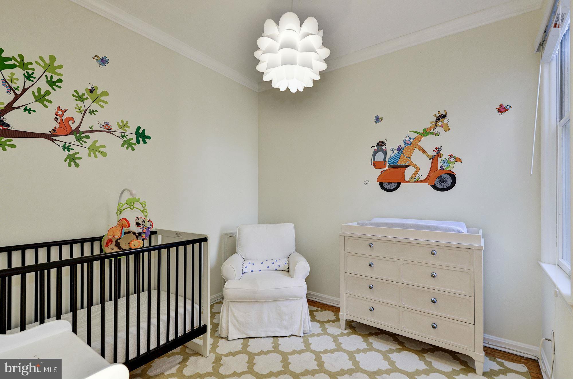 17 15th Street Southeast Washington, DC 20003 - Photo 18 of 28 a bedroom with a bed and a chandelier