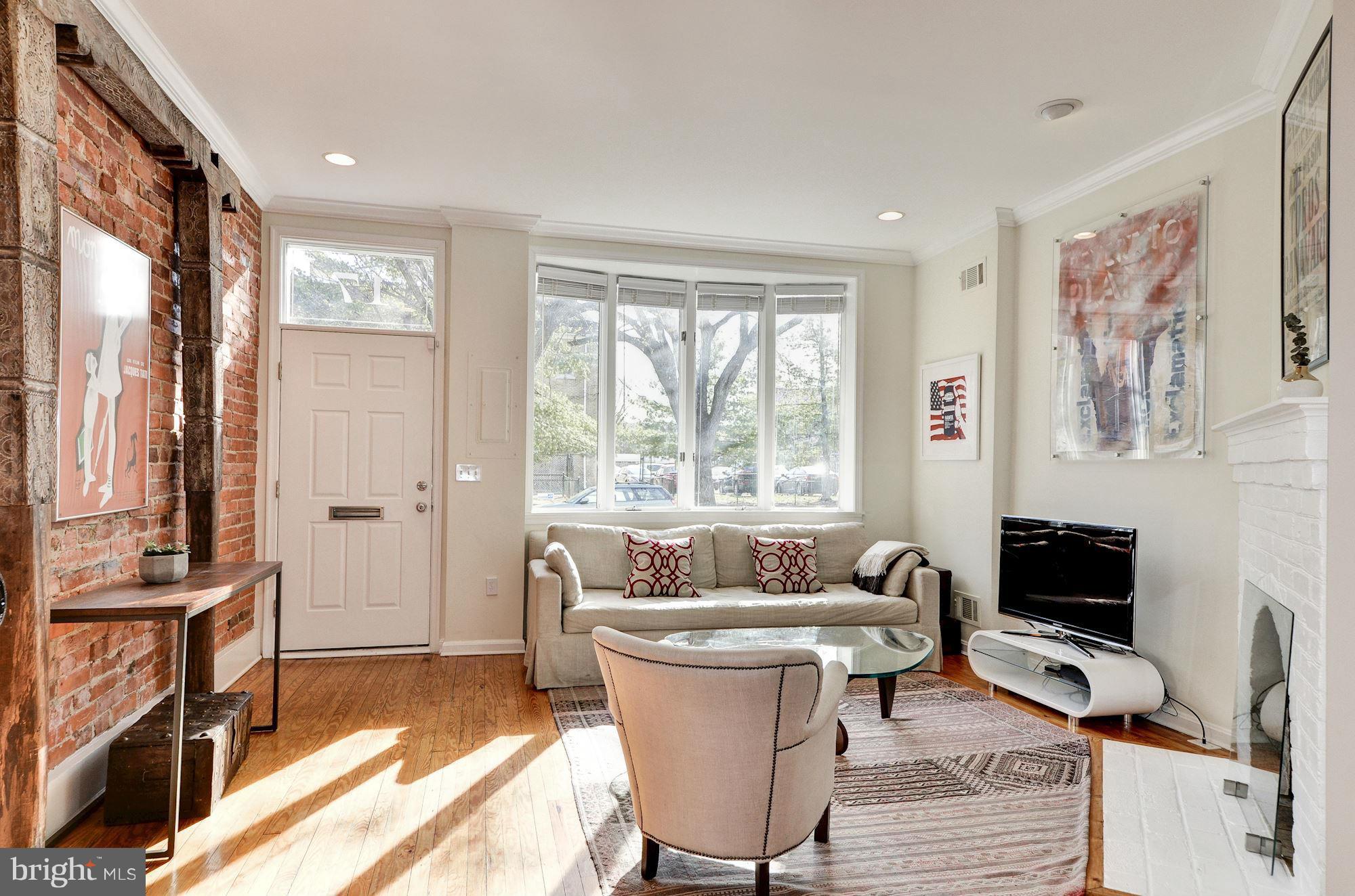 17 15th Street Southeast Washington, DC 20003 - Photo 3 of 28 a living room with furniture and a flat screen tv