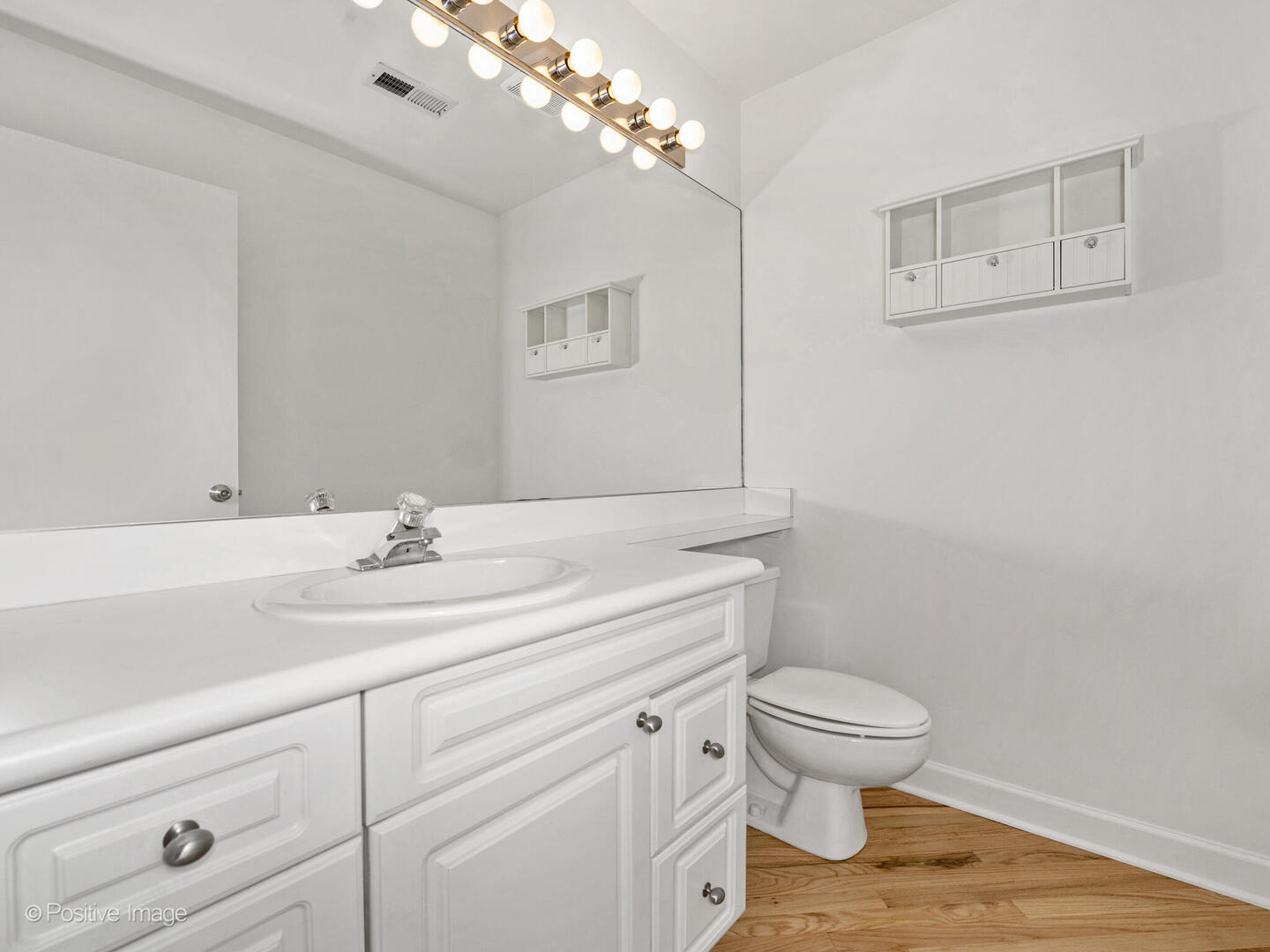 616 West Fulton Street, Unit 614 Chicago, IL 60661 - Photo 12 of 27 a bathroom with a toilet a sink and mirror