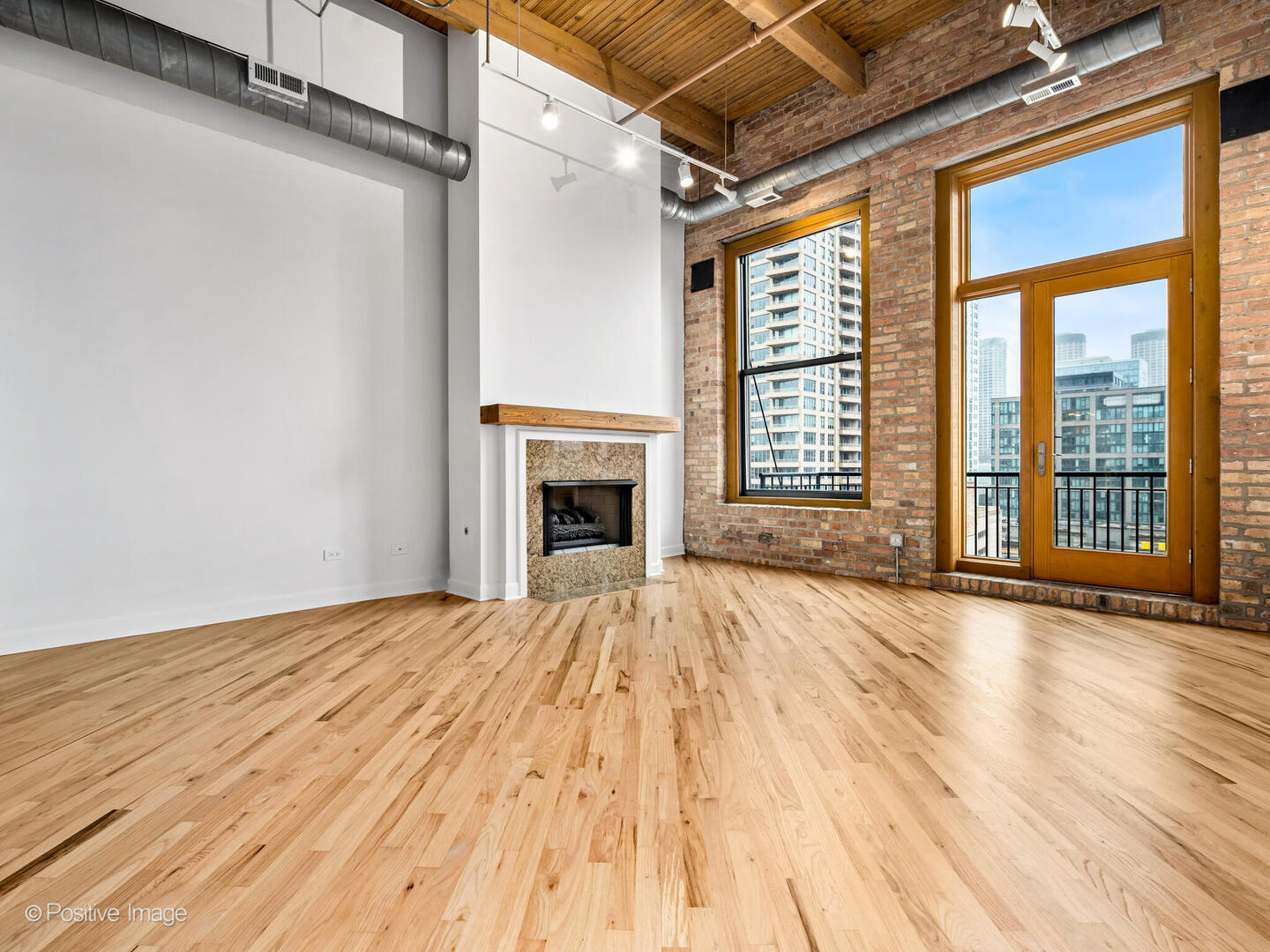 616 West Fulton Street, Unit 614 Chicago, IL 60661 - Photo 16 of 27 a view of an empty room with wooden floor and a window