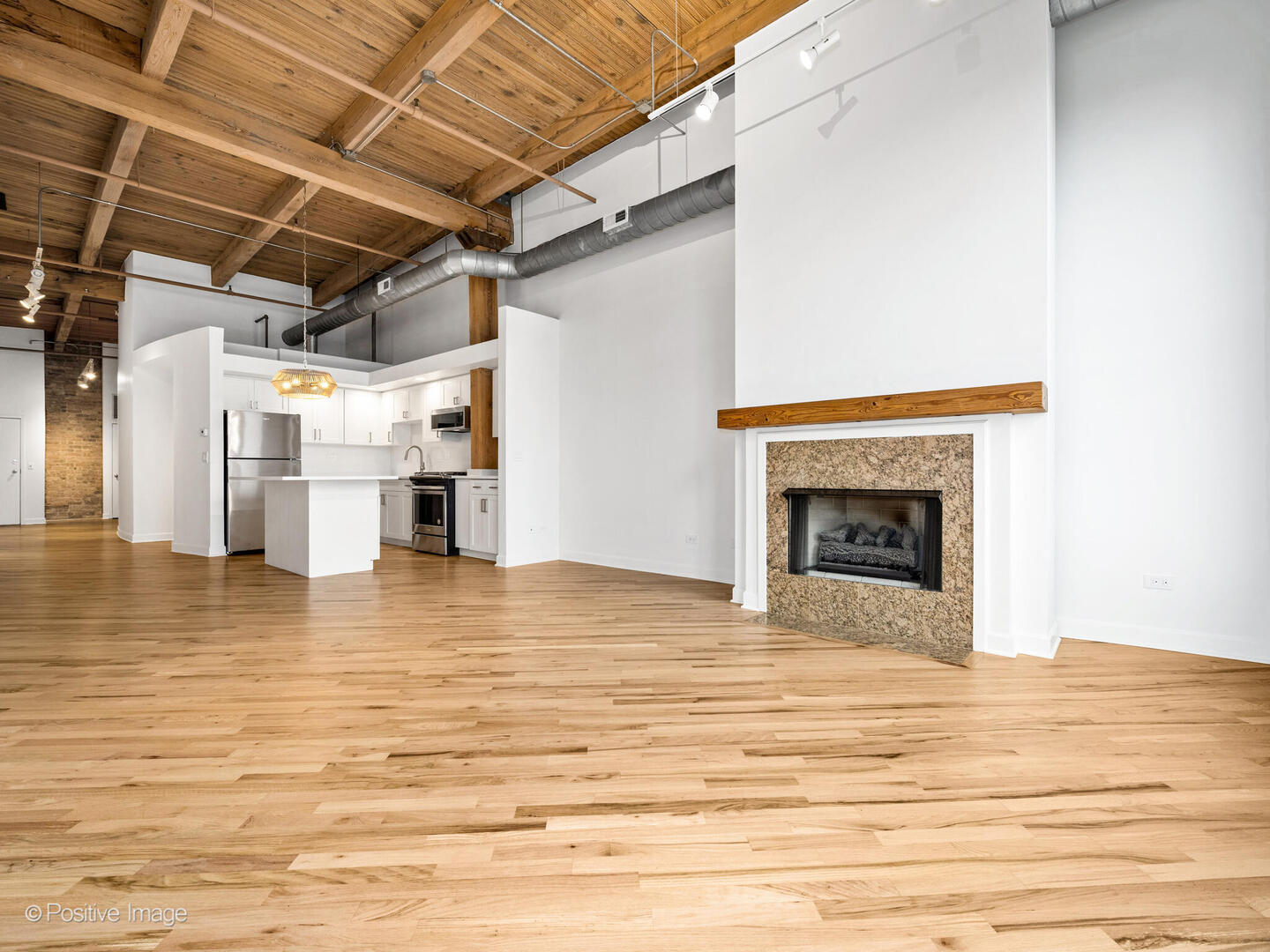 616 West Fulton Street, Unit 614 Chicago, IL 60661 - Photo 17 of 27 a view of empty room with wooden floor and fireplace