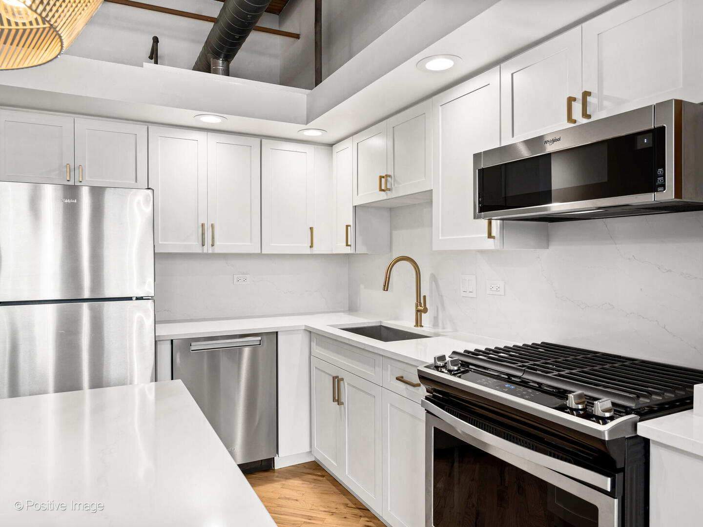 616 West Fulton Street, Unit 614 Chicago, IL 60661 - Photo 4 of 27 a kitchen with stainless steel appliances a sink a stove a microwave and cabinets