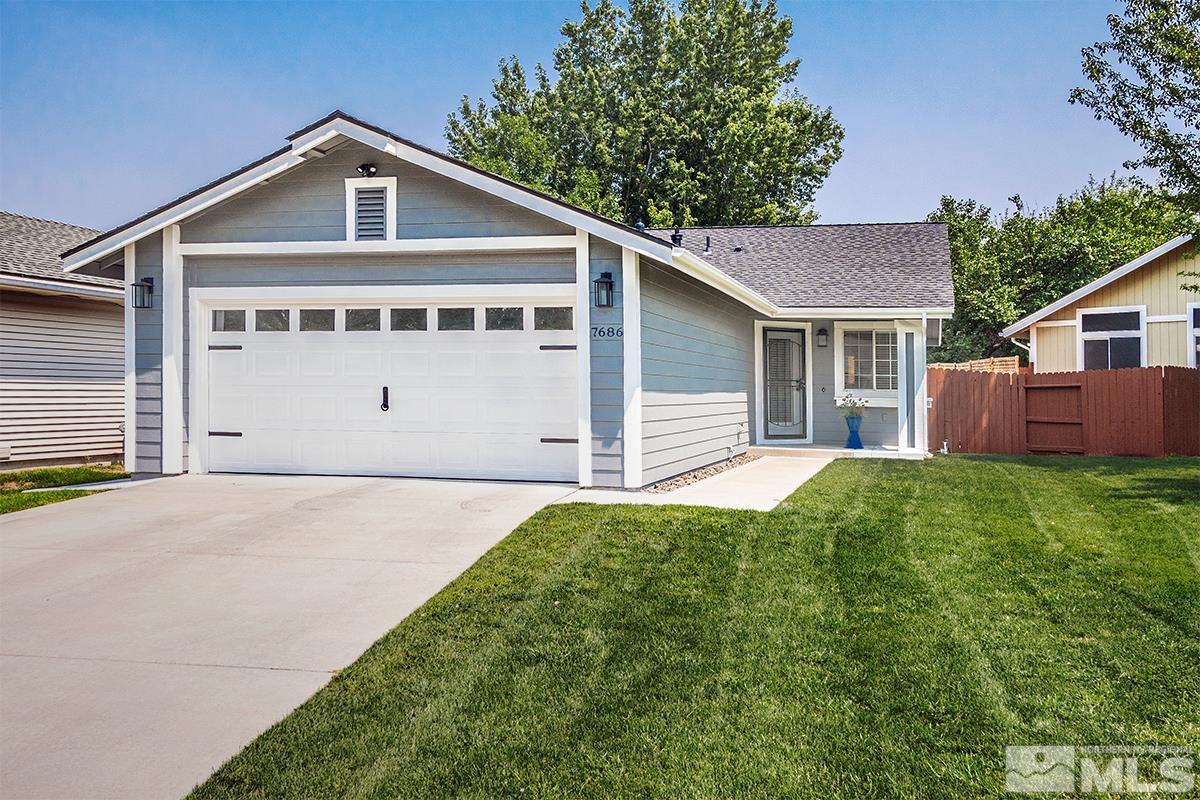 7686 Barnsdale Road Reno, NV 89511 - Photo 1 of 27 a front view of a house with a yard and garage