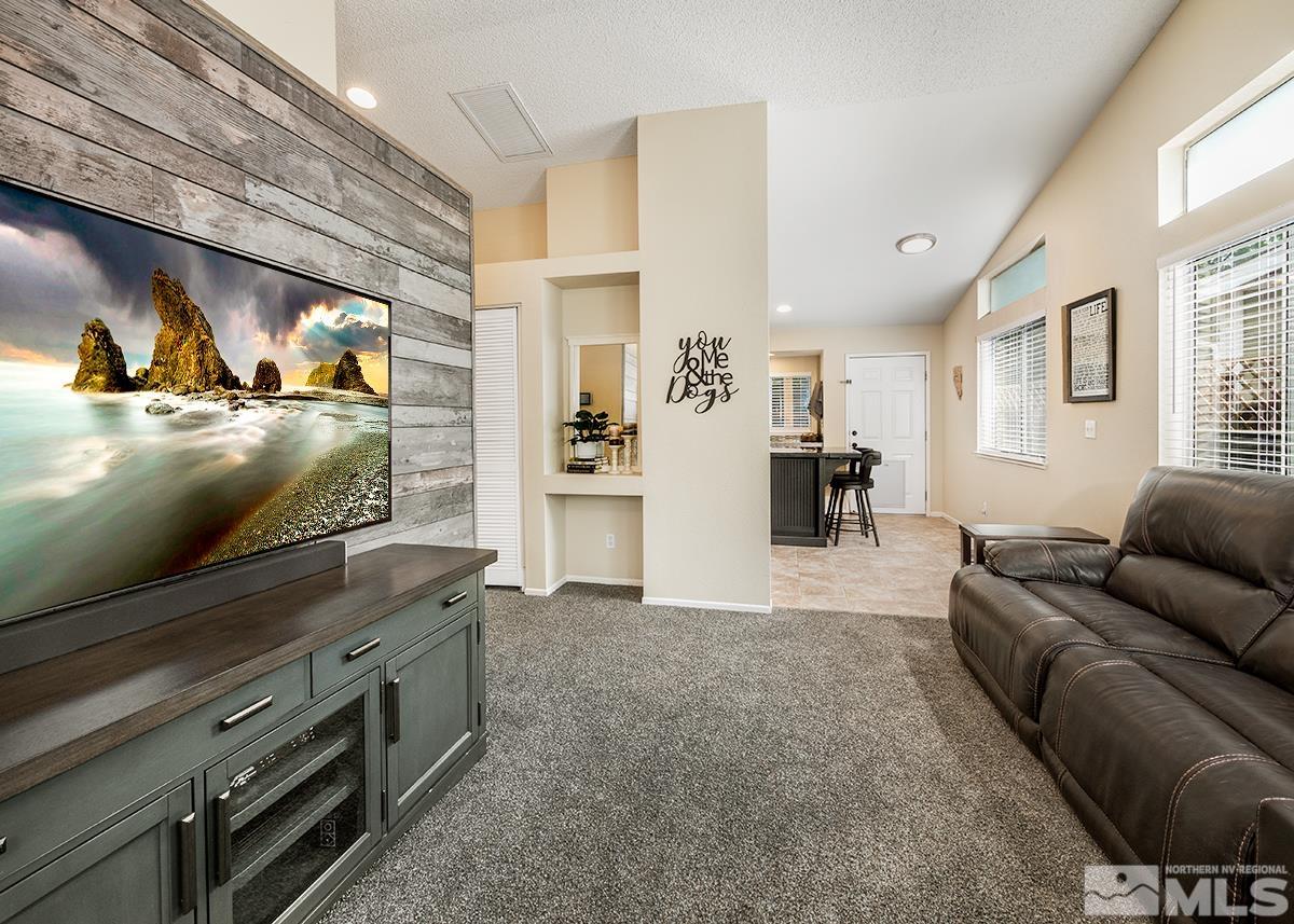 7686 Barnsdale Road Reno, NV 89511 - Photo 3 of 27 a living room with furniture and a flat screen tv