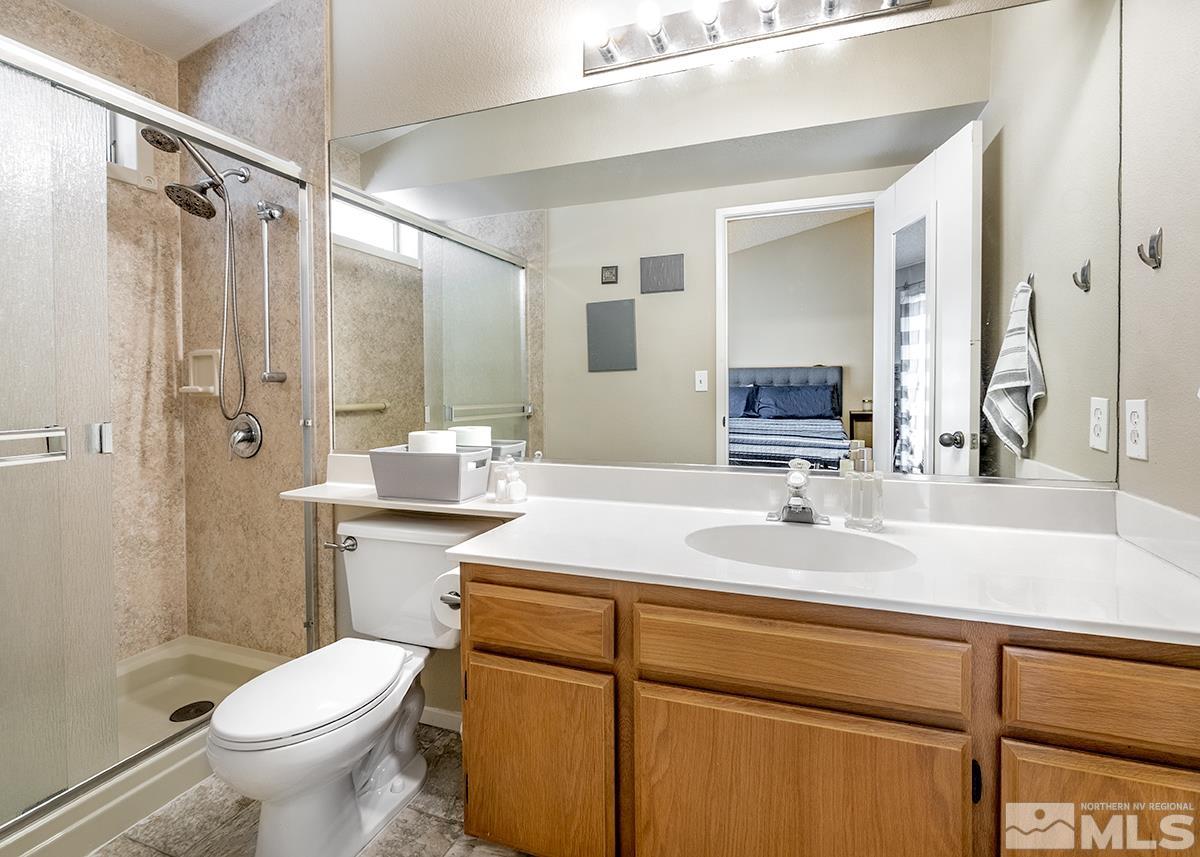 7686 Barnsdale Road Reno, NV 89511 - Photo 7 of 27 a bathroom with a sink toilet vanity and shower