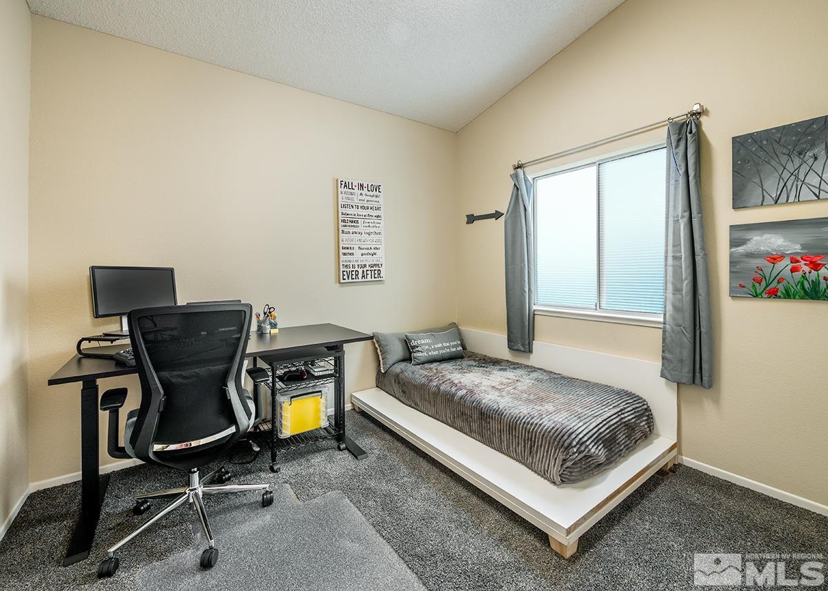 7686 Barnsdale Road Reno, NV 89511 - Photo 8 of 27 a bedroom with a bed and a table in it