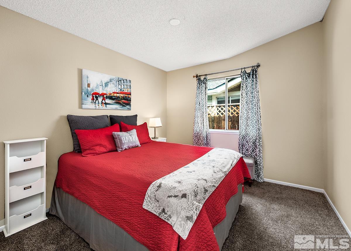 7686 Barnsdale Road Reno, NV 89511 - Photo 10 of 27 a bedroom with bed and a window