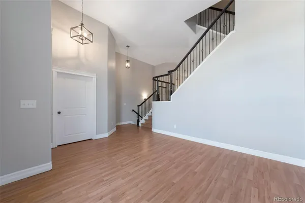 a view of an entryway with wooden floor