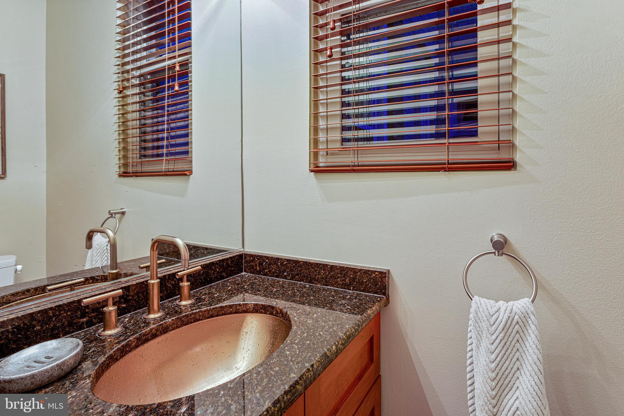 144 Tennessee Avenue Northeast Washington, DC 20002 - Photo 20 of 68 a bathroom with a granite countertop sink and a mirror