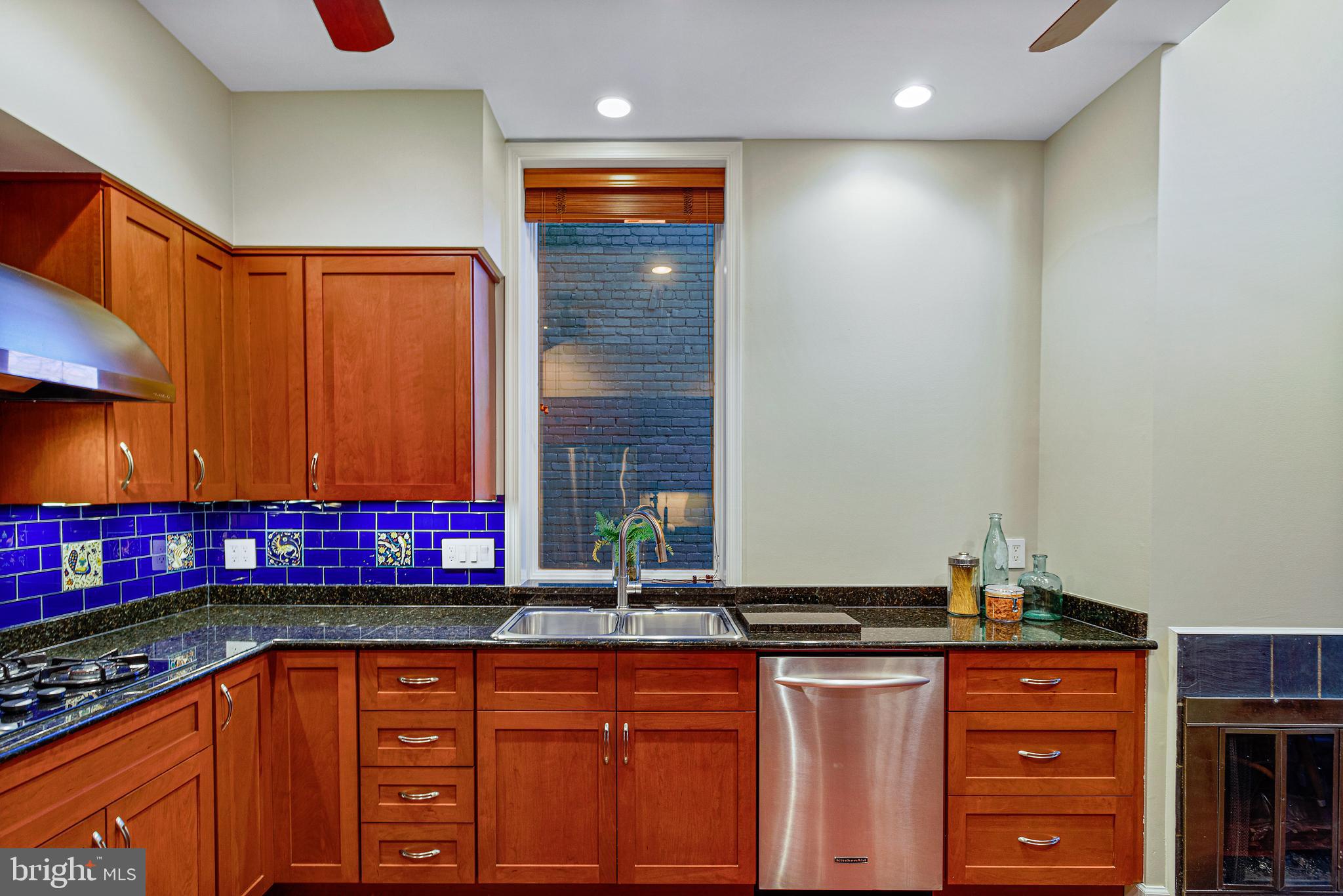 144 Tennessee Avenue Northeast Washington, DC 20002 - Photo 25 of 68 a kitchen with stainless steel appliances granite countertop a stove a sink and a microwave