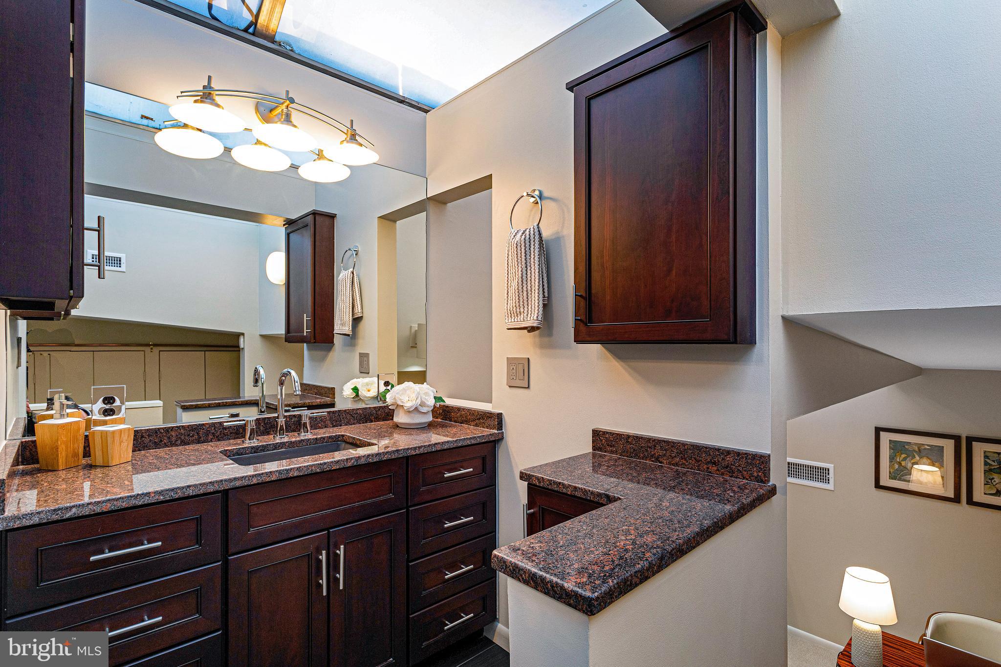 144 Tennessee Avenue Northeast Washington, DC 20002 - Photo 43 of 68 a kitchen with granite countertop a sink cabinets and stainless steel appliances