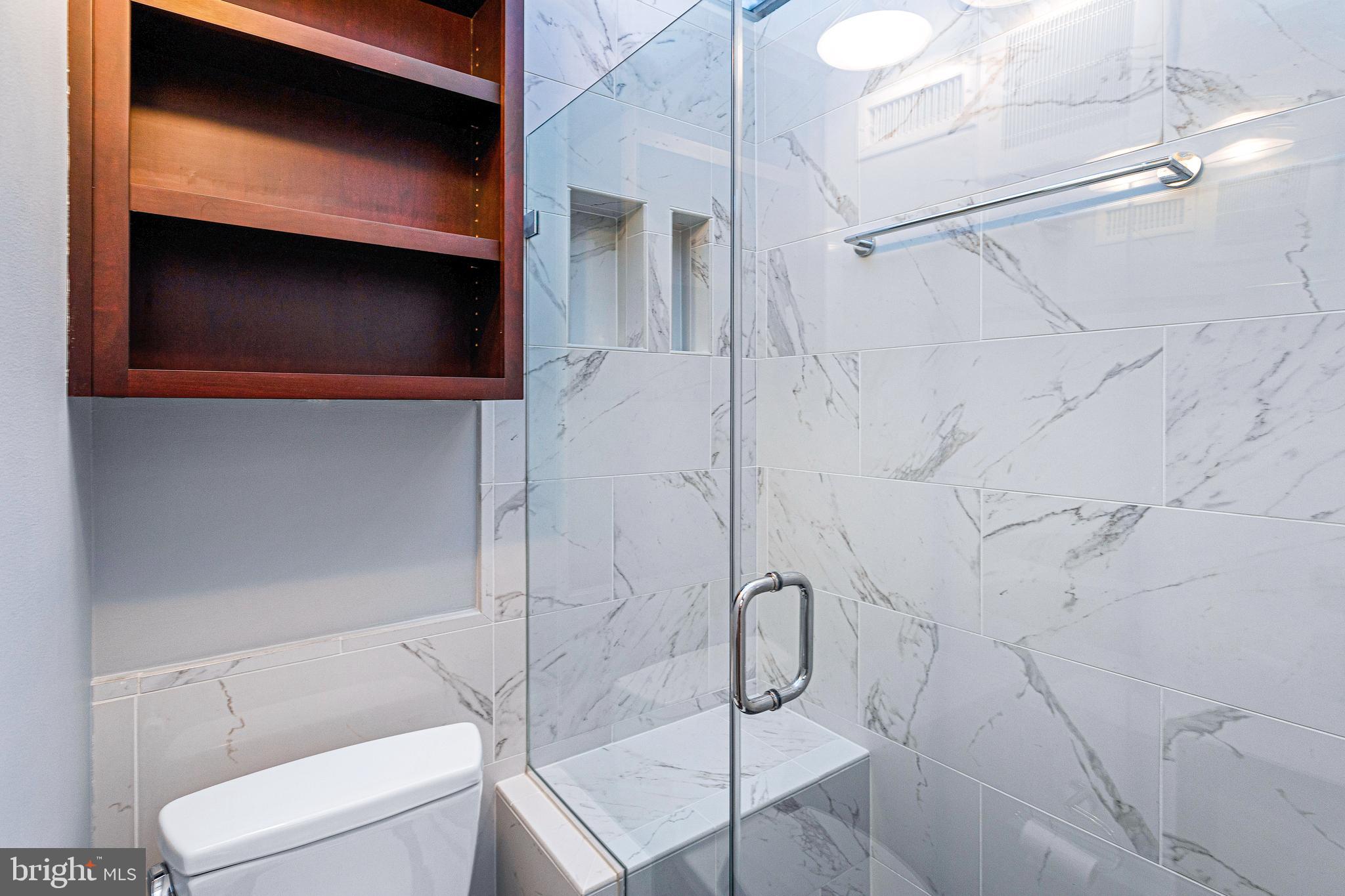 144 Tennessee Avenue Northeast Washington, DC 20002 - Photo 44 of 68 a bathroom with a shower and a mirror