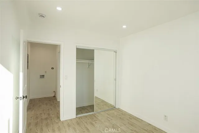 an empty room with wooden floor