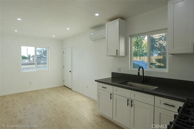 a kitchen with granite countertop a sink and a window