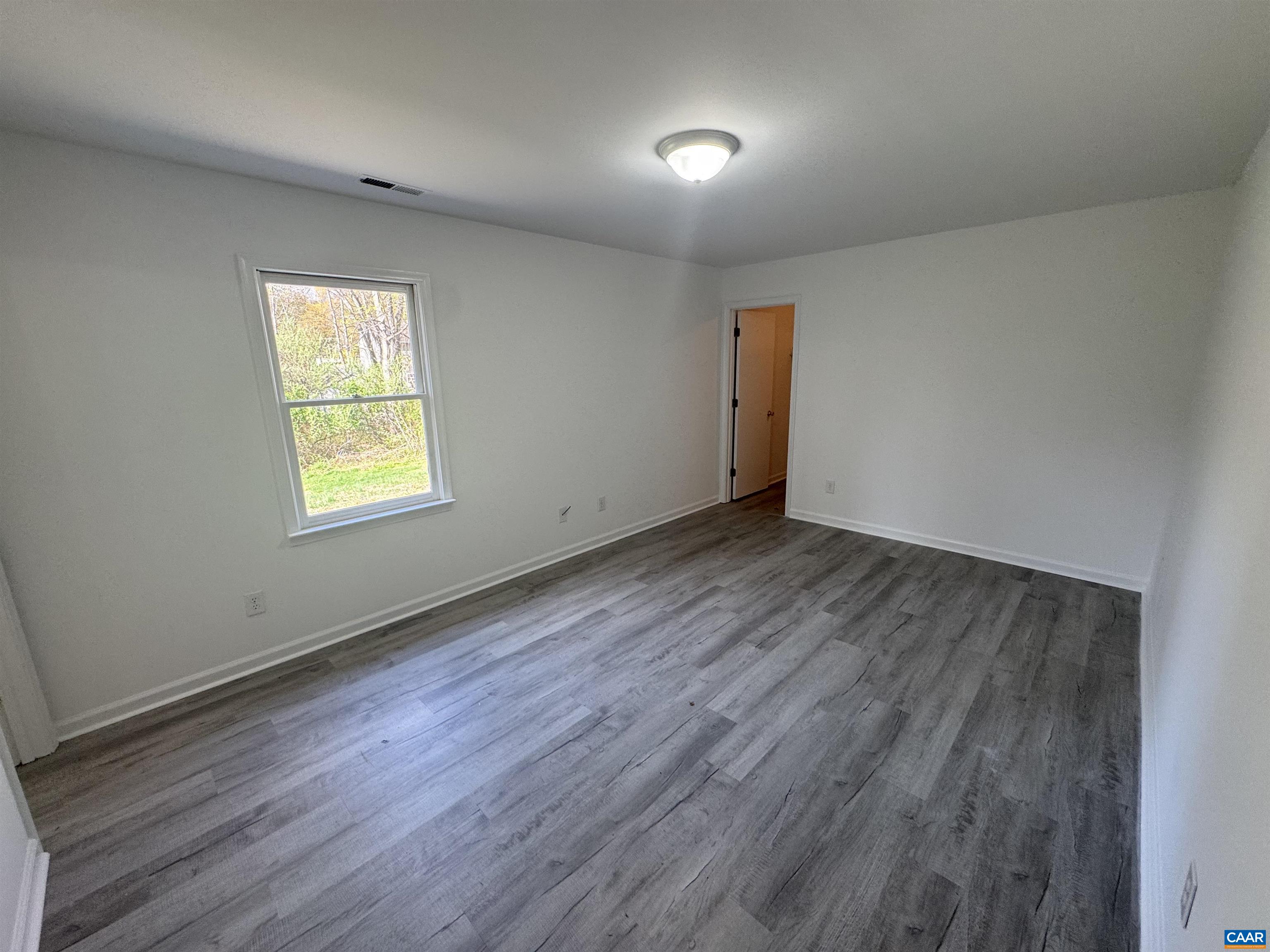 109 Narcissus Road Ruckersville, VA 22968 - Photo 13 of 27 an empty room with wooden floor and windows
