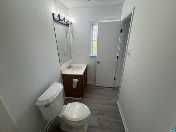 a white toilet sitting next to a bathroom sink