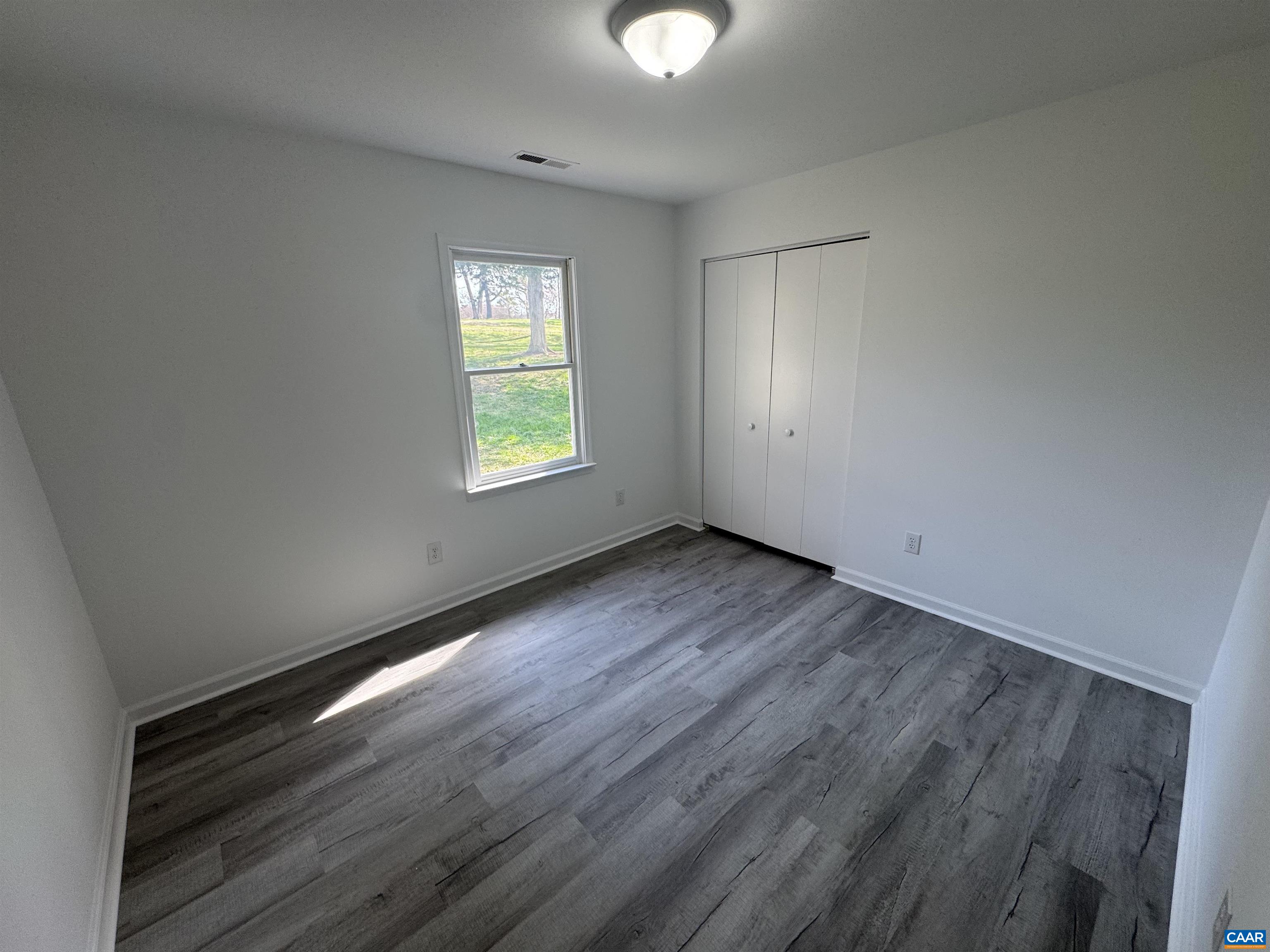 109 Narcissus Road Ruckersville, VA 22968 - Photo 18 of 27 a view of an empty room with wooden floor and a window