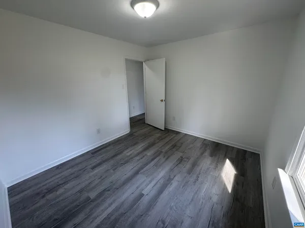 a view of an empty room and wooden floor