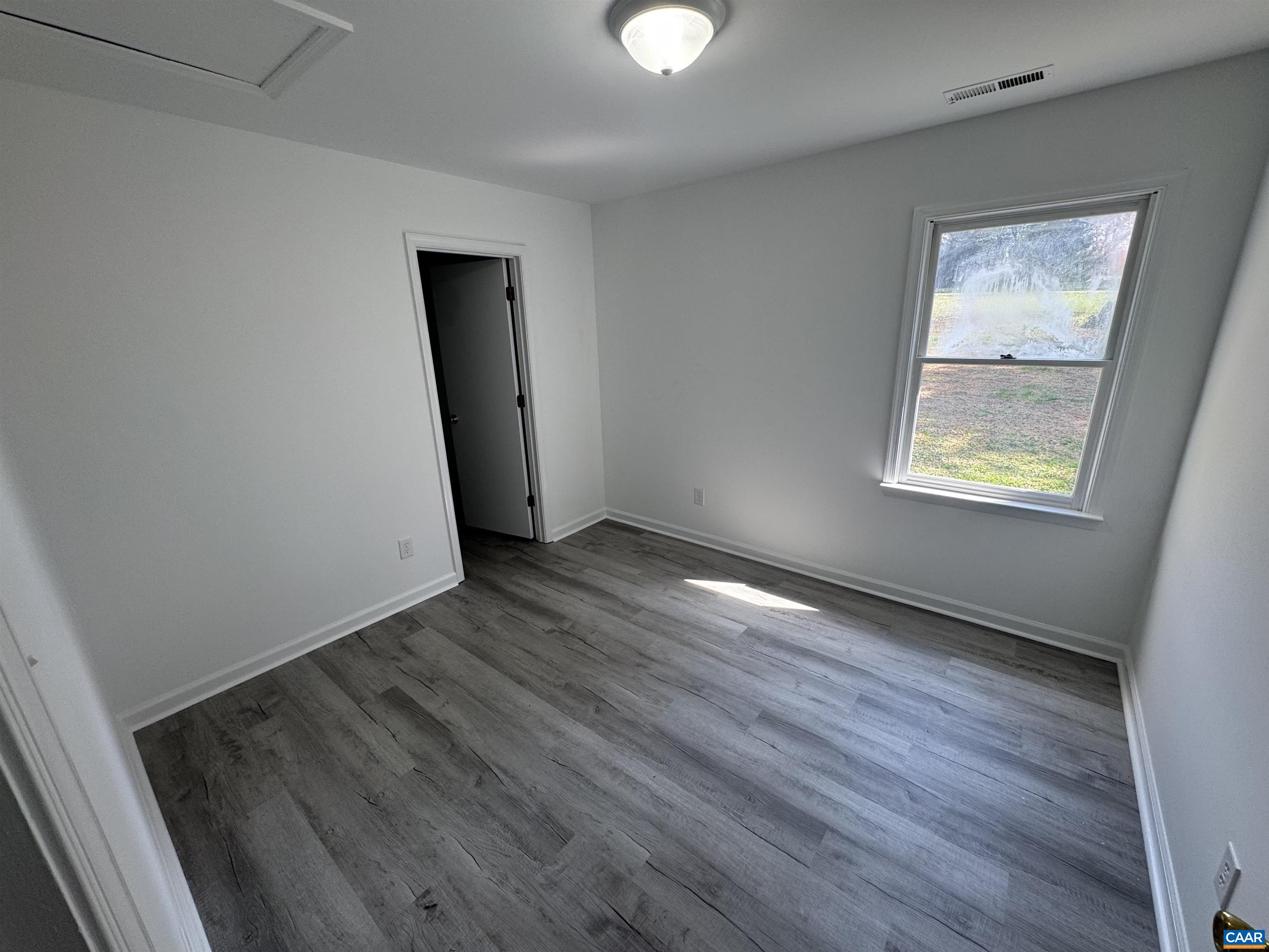 109 Narcissus Road Ruckersville, VA 22968 - Photo 20 of 27 a view of an empty room with wooden floor and a window