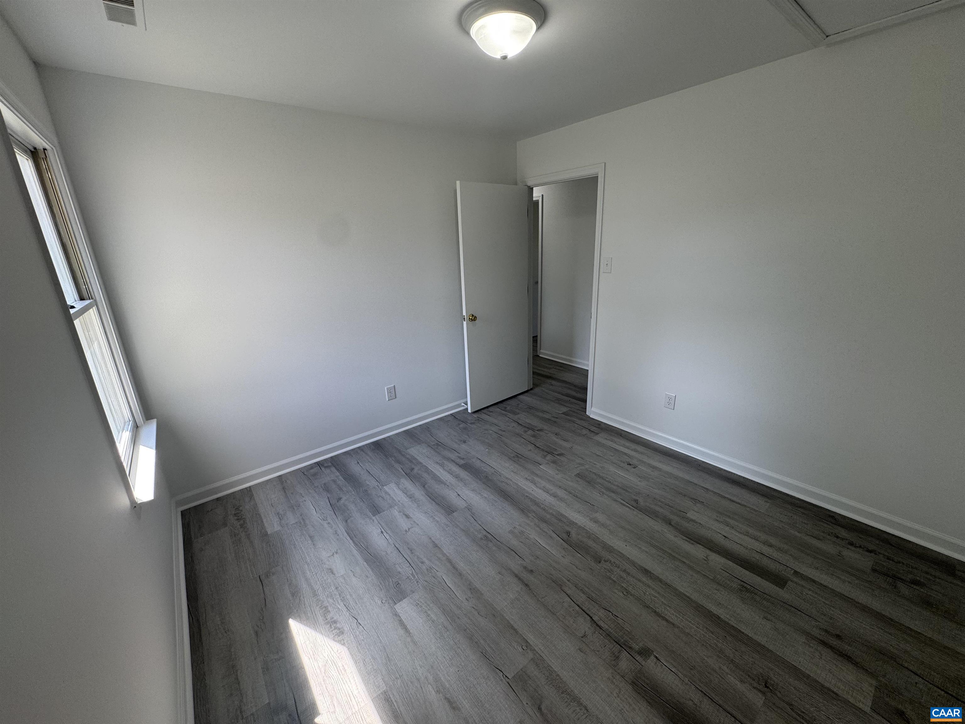 109 Narcissus Road Ruckersville, VA 22968 - Photo 21 of 27 a view of an empty room with wooden floor and a window