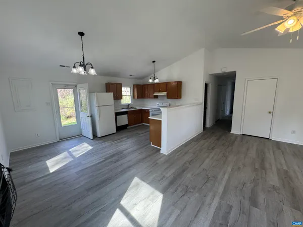 a view of a kitchen and dining room with wooden floor
