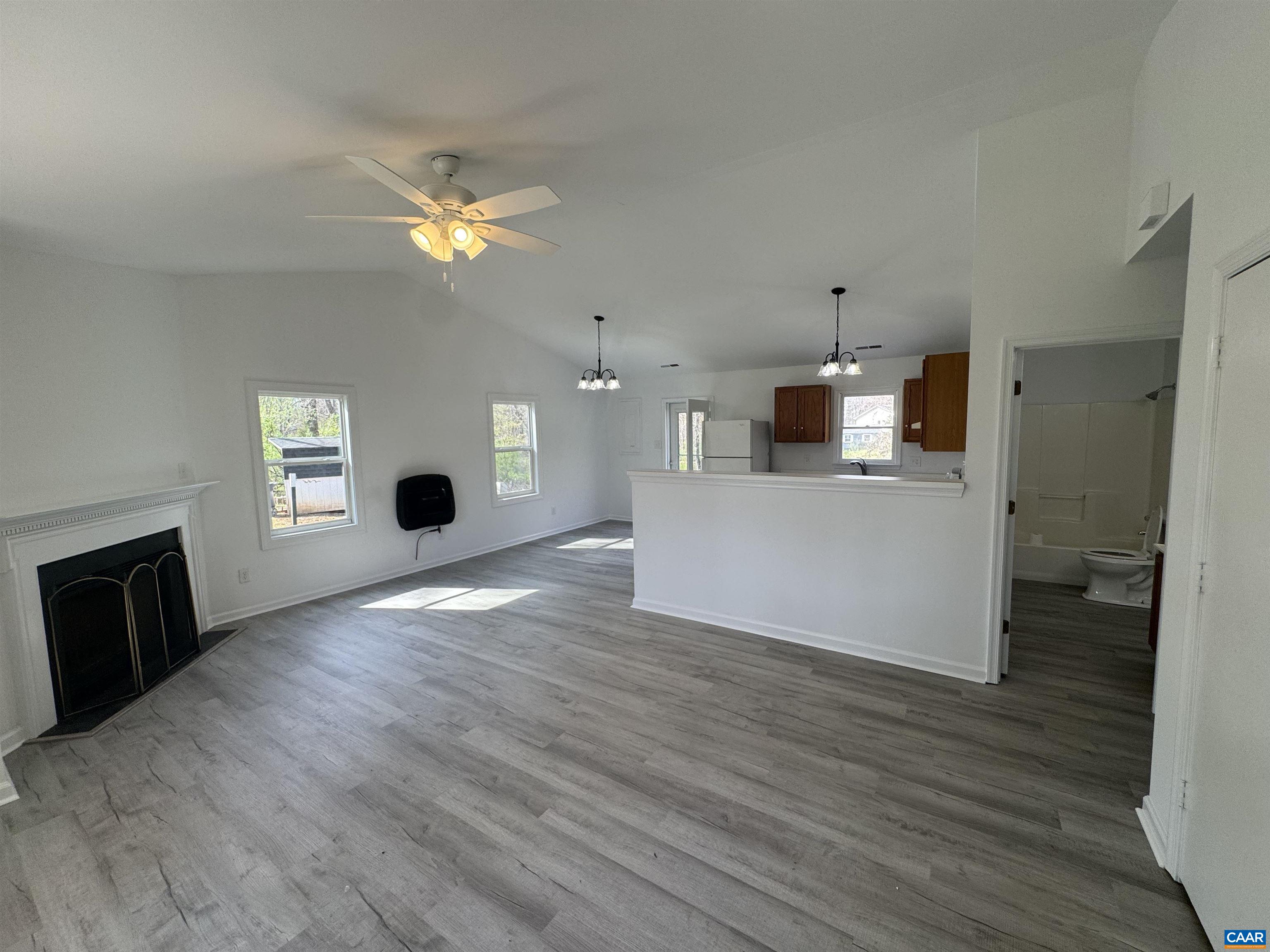109 Narcissus Road Ruckersville, VA 22968 - Photo 10 of 27 a view of a kitchen with a sink a microwave and a fireplace