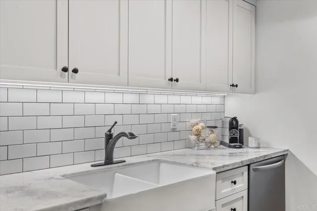 a bathroom with a sink and cabinets