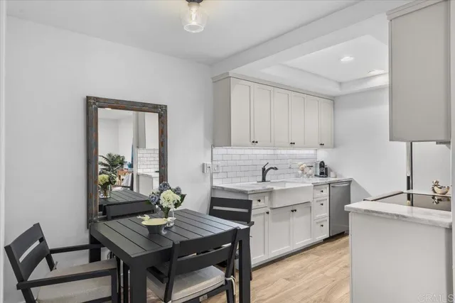 a view of a kitchen area with furniture and wooden floor