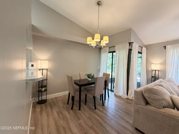 a view of a dining room with furniture and wooden floor