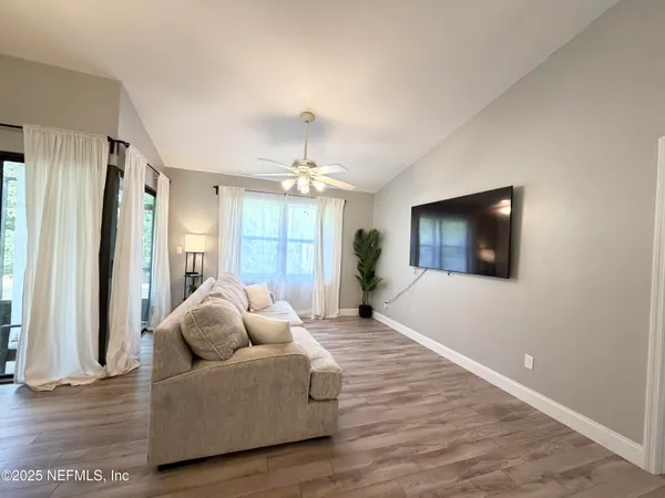 a living room with furniture and a flat screen tv
