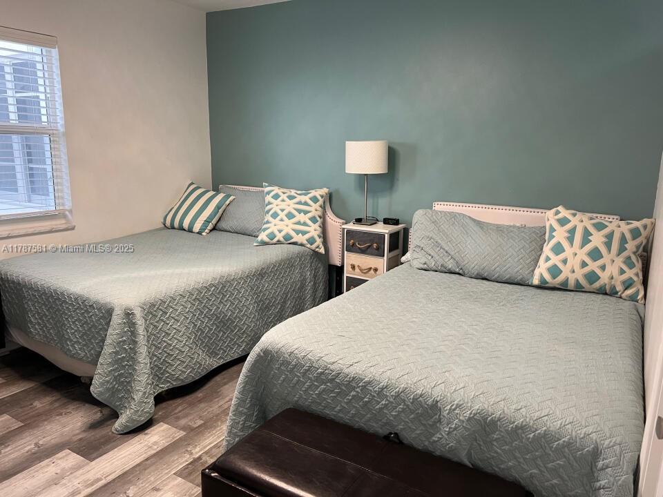 1500 South Ocean Boulevard, Unit 907 Pompano Beach, FL 33062 - Photo 11 of 14 a bedroom with two beds and wooden floor