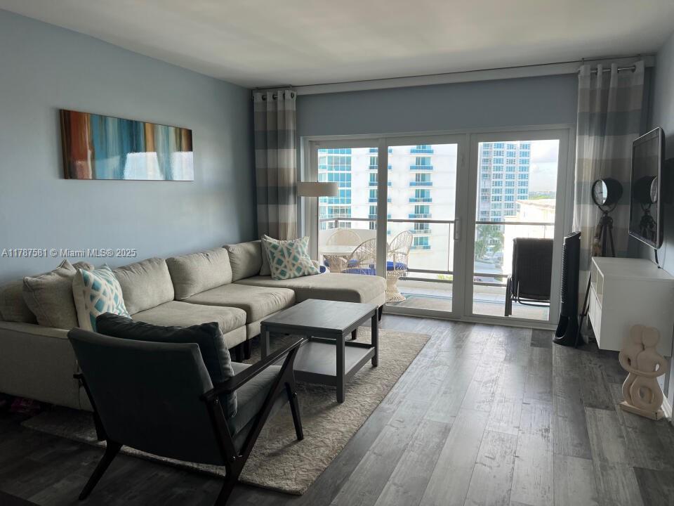 1500 South Ocean Boulevard, Unit 907 Pompano Beach, FL 33062 - Photo 3 of 14 a living room with furniture and a floor to ceiling window