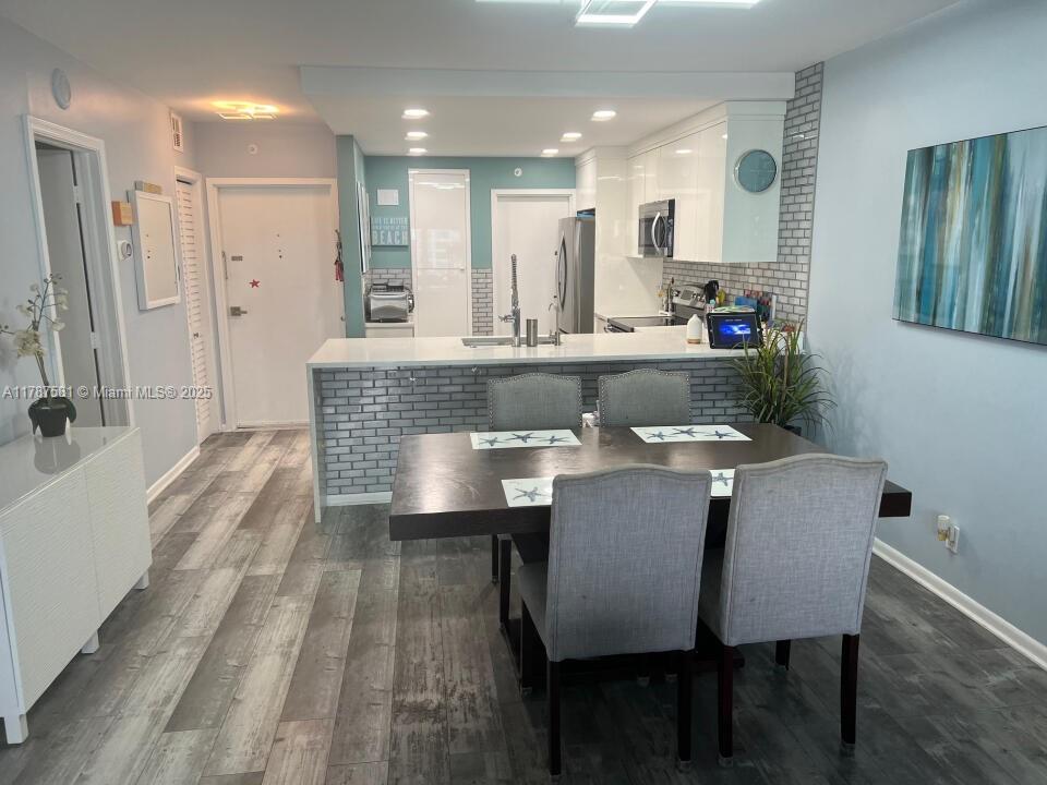 1500 South Ocean Boulevard, Unit 907 Pompano Beach, FL 33062 - Photo 4 of 14 a view of a dining room with furniture and wooden floor