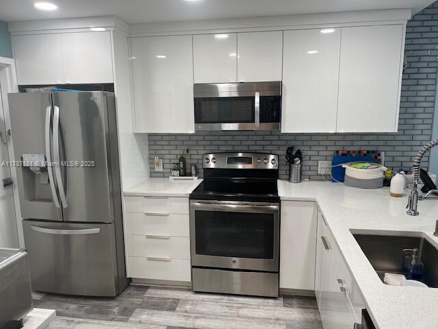 1500 South Ocean Boulevard, Unit 907 Pompano Beach, FL 33062 - Photo 8 of 14 a kitchen with stainless steel appliances a refrigerator a sink a stove a microwave and cabinets
